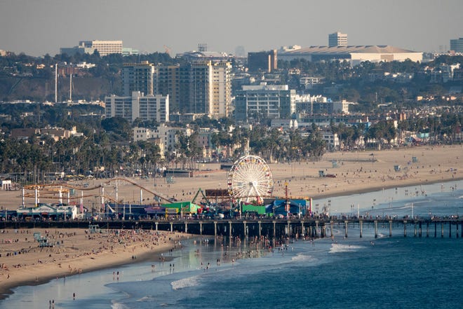 An overhead shot of the Santa Monica Pier and Pacific Park from nearby Pacific Palisades.