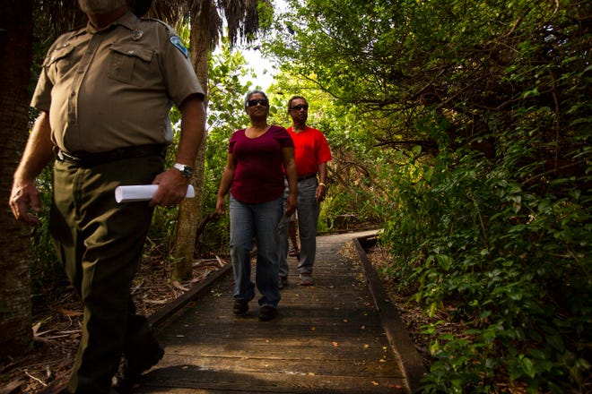 Ranger Bill Thaller of Florida Park Services takes Naples residents Monisha and Tam Mustapha on a guided nature tour through Delnor-Wiggins Pass State Park on Thursday morning, Dec. 13, 2018. The weekly tour had been discontinued after Hurricane Irma hit Collier County in September 2017.
