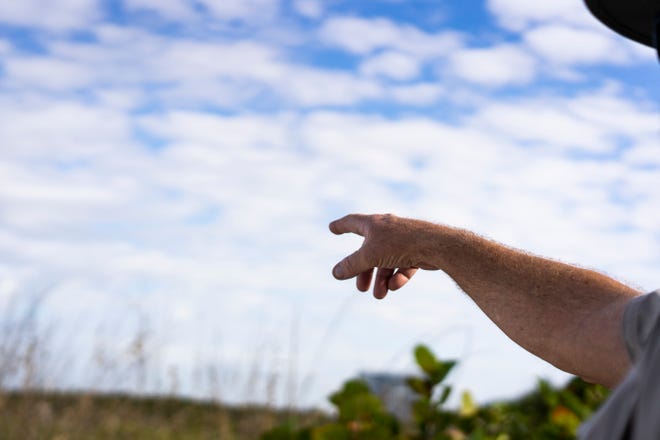 Ranger Bill Thaller for Florida Park Services points towards the Delnor-Wiggins Pass from the state park to his tour.  The tours of natural communities of a Barrier Island, was discontinued after Hurricane Irma hit Collier County in September 2017.