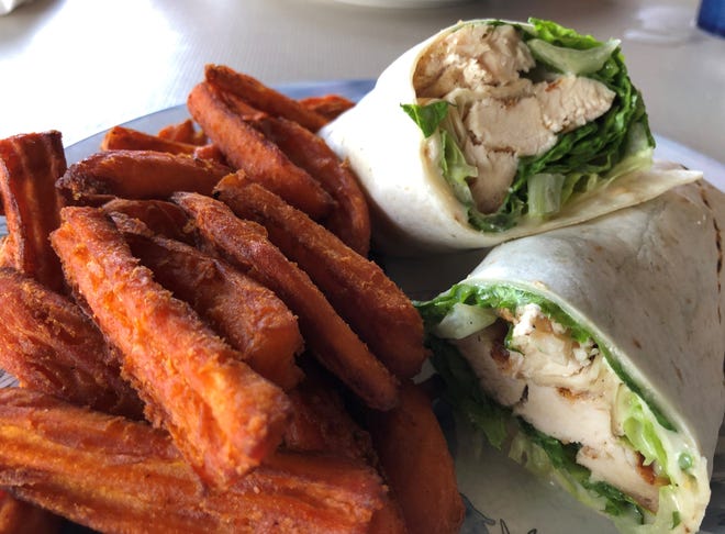 The chicken Cesar wrap and sweet potato fries from Capri Fish House.
