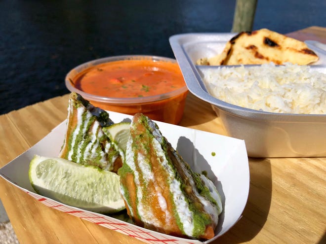 Crisp samosas filled with potatoes, peas and spices, and chicken tikka masala from I Love Curry, a food truck at Celebration Park.
