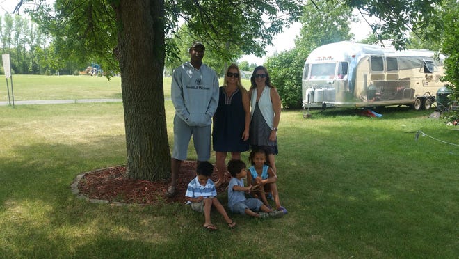 (From left to right) Dion Cox, Misty Latham, and Carly Cox of North Dakota behind Eli Cox, Reggie Latham, and Nya Cox. The Cox family owns a 1976 Airstream.