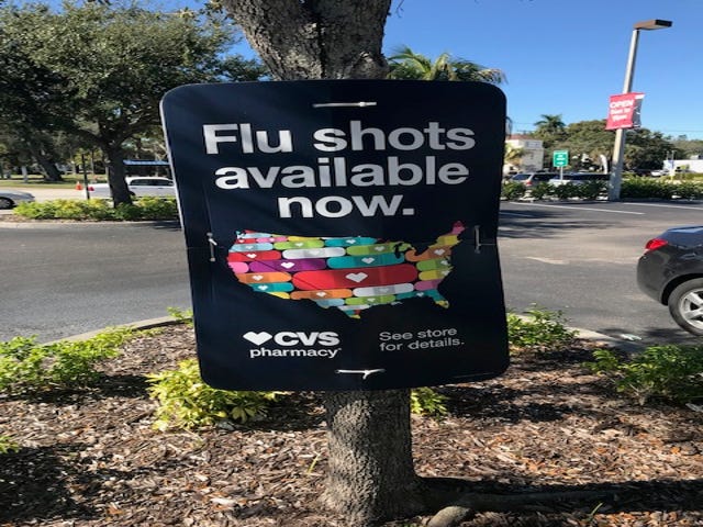 A CVS sign announce flu shots are available.