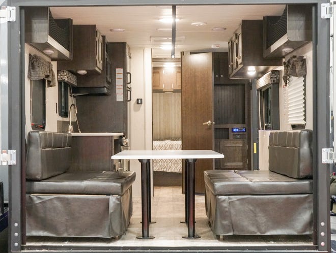 The couches on the sides of this RV fold up, and the table can be removed, to fit gear or an ATV or bikes inside.