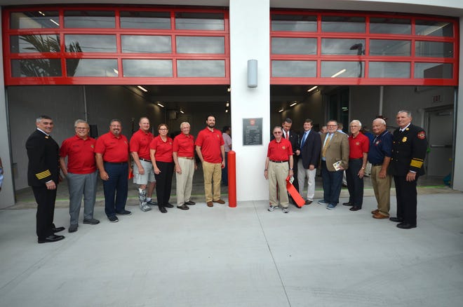 Flanked by Deputy Chief David Batiato, left, and Chief Mike Murphy, city councilors and dignitaries pose for a group photo. The Marco Island Fire-Rescue Department dedicated their newly reopened Fire Station 51 in a ceremony Friday afternoon.
