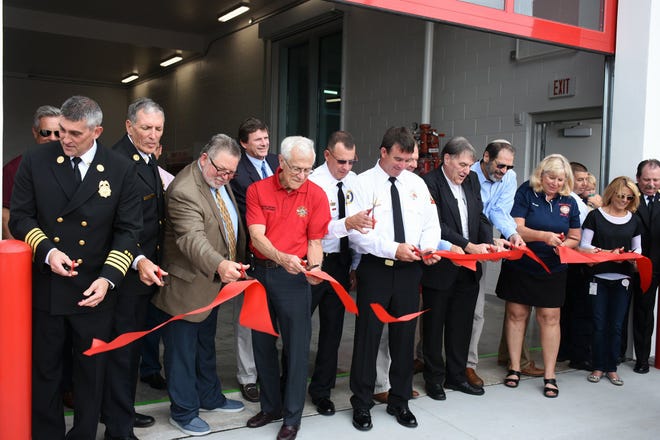 Everybody gets into the act for the official ribbon cutting. The Marco Island Fire-Rescue Department dedicated their newly reopened Fire Station 51 in a ceremony Friday afternoon.