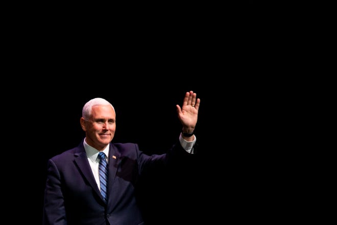 Vice President Mike Pence waves to a crowd before his speech at the O'Bryan Performance Hall in the Thomas and Selby Prince Building at Ave Maria University on Thursday, March 28, 2019.