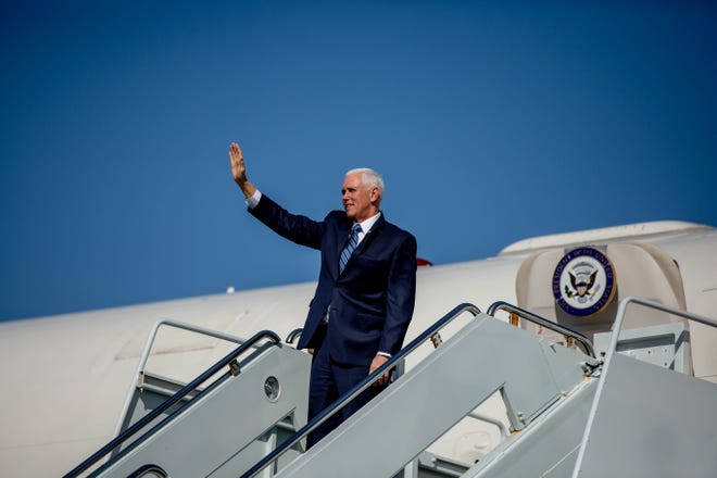 Vice President Mike Pence waves as he exits Air Force Two and greets those waiting on his arrival at the Naples Airport on Thursday, March 28, 2019.