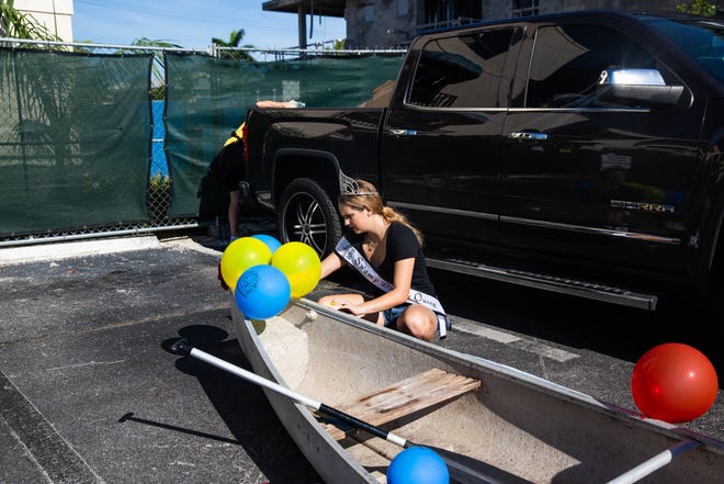 Swamp Buggy Queen Courtney Mee decorates her canoe for the Theme Canoe Parade at the 43rd annual Great Dock Canoe Race in Naples on Saturday, May 11, 2019.