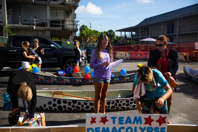 Participants decorate canoes for the Theme Canoe Parade at the 43rd annual Great Dock Canoe Race in Naples on Saturday, May 11, 2019.