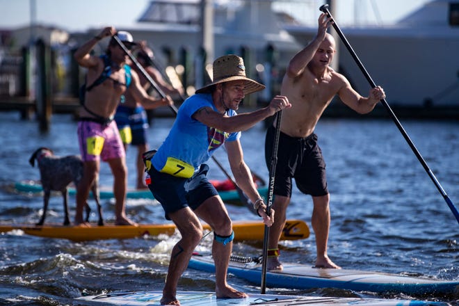 Simon Tracy of Naples competes in the amateur stand up paddleboard race, Saturday, May 11, 2019, during the 43rd annual Great Dock Canoe Race at Crayton Cove in Naples.
