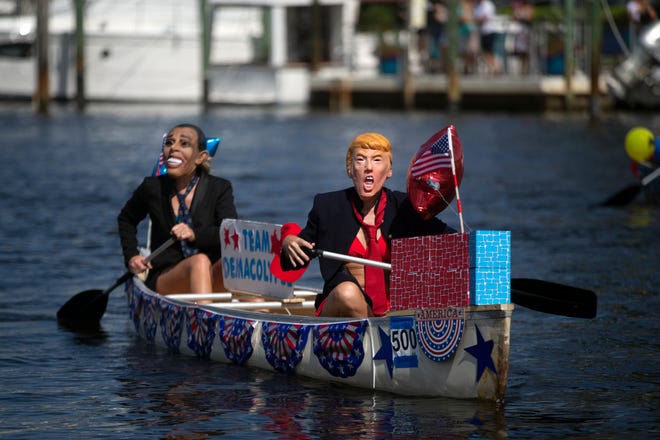 Ashley Nichols, left, and Naomi Mizracho both from Naples participate in the themed canoe parade, Saturday, May 11, 2019, during the 43rd annual Great Dock Canoe Race at Crayton Cove in Naples.