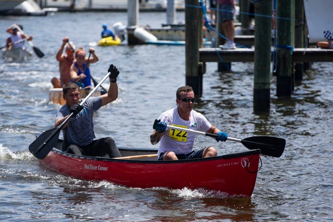 Canoe racers paddle their way to the finish line, Saturday, May 11, 2019, during the 43rd annual Great Dock Canoe Race at Crayton Cove in Naples.