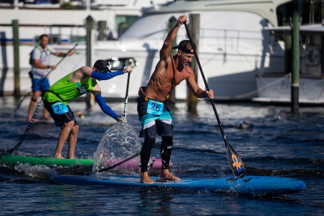Mark Athanacio from Bonita Springs, competes in the professional paddleboard race, Saturday, May 11, 2019, during the 43rd annual Great Dock Canoe Race at Crayton Cove in Naples.