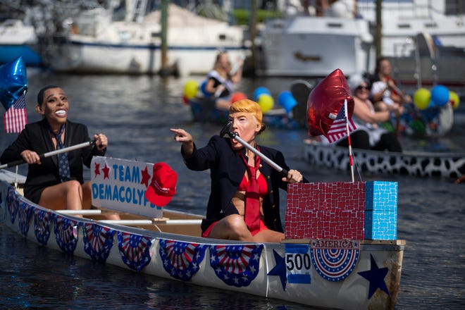 Ashley Nichols, left, and Naomi Mizracho both from Naples participate in the themed canoe parade, Saturday, May 11, 2019, during the 43rd annual Great Dock Canoe Race at Crayton Cove in Naples.