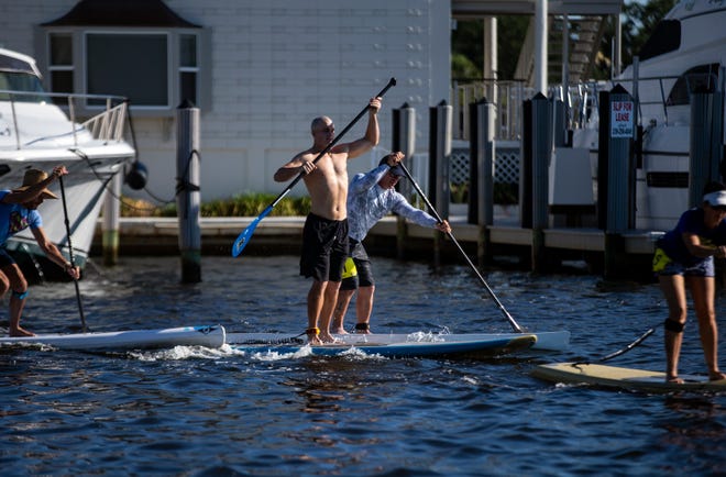 Amateur stand up paddleboard racers compete, Saturday, May 11, 2019, at the 43rd annual Great Dock Canoe Race at Crayton Cove in Naples.