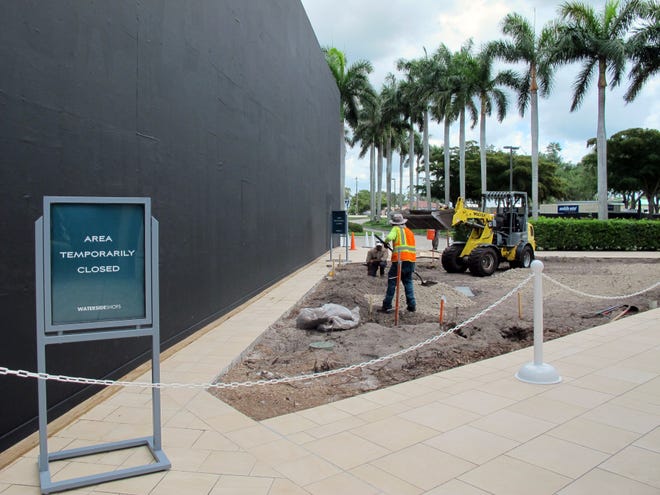 The Apple store at Waterside Shops in Naples looks similar to an iPhone box, left, while under construction on the eastern edge of the mall in preparation for its reopening this fall.