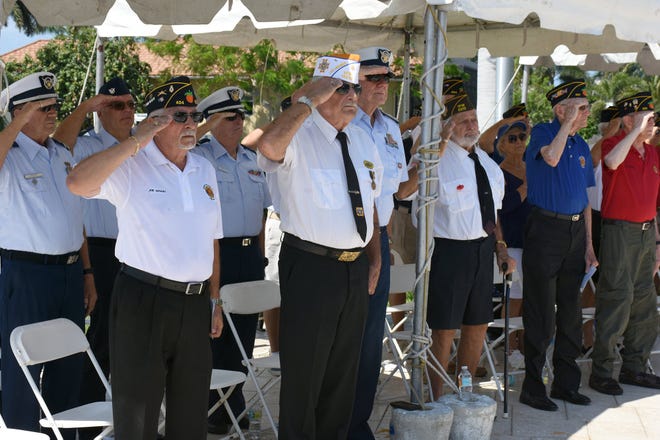 Veterans salute the colors. Marco Island commemorated Memorial Day on Monday morning with a ceremony at Veterans' CommunityPark, with a keynote address by American Legion Post #404 Commander Lee Rubenstein.