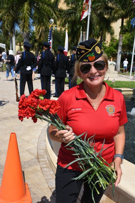 Lee Ross of the American Legion gives out carnations. Marco Island commemorated Memorial Day on Monday morning with a ceremony at Veterans' CommunityPark, with a keynote address by American Legion Post #404 Commander Lee Rubenstein.