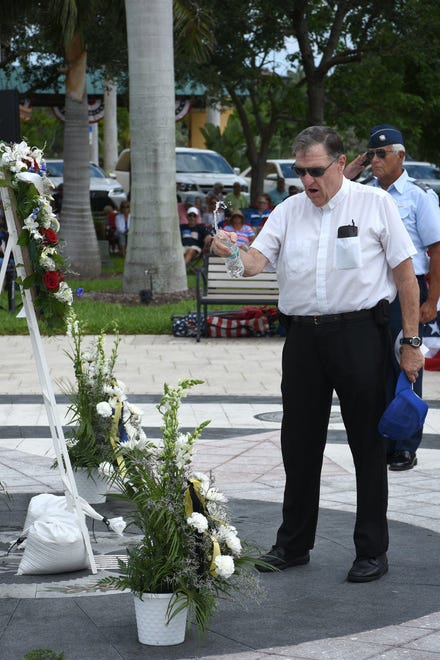 Father Tim Navin of San Marco Catholic Church anoints commemorative wreaths. Marco Island commemorated Memorial Day on Monday morning with a ceremony at Veterans' CommunityPark, with a keynote address by American Legion Post #404 Commander Lee Rubenstein.