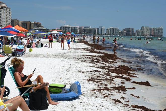 Brown seagrass lined Residents' Beach. Marco Island's Fourth of July was a day at the beach, with activities, splashing and thousands thronging the shore for Uncle Sam's Sand Jam.