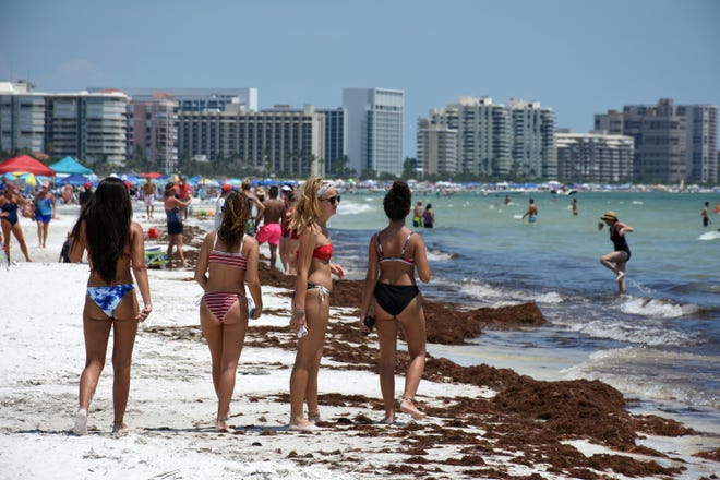 Bikinis and brown seagrass lined Residents' Beach. Marco Island's Fourth of July was a day at the beach, with activities, splashing and thousands thronging the shore for Uncle Sam's Sand Jam.