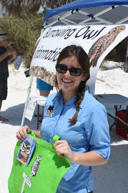 Alli Smith of Audubon Florida dispenses burrowing owl information right next to a beachside burrow. Marco Island's Fourth of July was a day at the beach, with activities, splashing and thousands thronging the shore for Uncle Sam's Sand Jam.