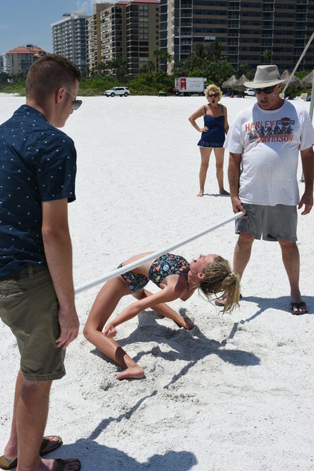 How low can you go? Kids compete in the limbo contest. Marco Island's Fourth of July was a day at the beach, with activities, splashing and thousands thronging the shore for Uncle Sam's Sand Jam.