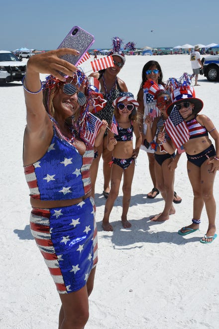 JoAnn Leonardi takes a selfie with Daniella Sandera, from left, Dionna Politi, Giuleana and Ale Sandera, all in for the red, white and blue. Marco Island's Fourth of July was a day at the beach, with activities, splashing and thousands thronging the shore for Uncle Sam's Sand Jam.