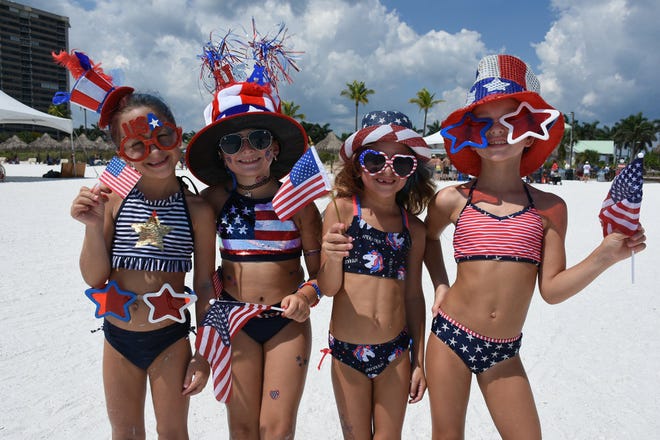 Daniella Sandera, from left, Dionna Politi, Giuleana and Ale Sandera go all in for the red, white and blue. Marco Island's Fourth of July was a day at the beach, with activities, splashing and thousands thronging the shore for Uncle Sam's Sand Jam.
