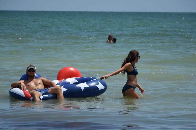 Clearly, this guy has life all figured out. Marco Island's Fourth of July was a day at the beach, with activities, splashing and thousands thronging the shore for Uncle Sam's Sand Jam.