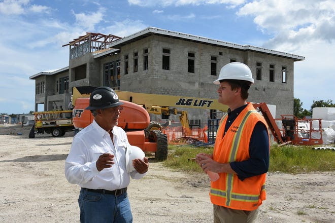 Airports manager Justin Lobb, right, talks with job superintendent Frank Alvarez near the new terminal building, scheduled to be complete this winter. The Marco Island Executive Airport on Mainsail Drive is undertaking roughly $13 million of new facilities' expansion.