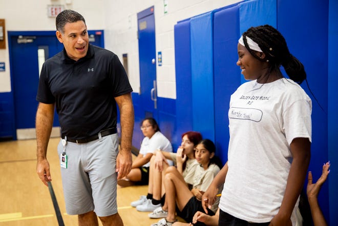 Chris Gelardi talks to Kirste Joseph during a physical education class at Golden Gate Middle School on Thursday, Aug. 22, 2019.