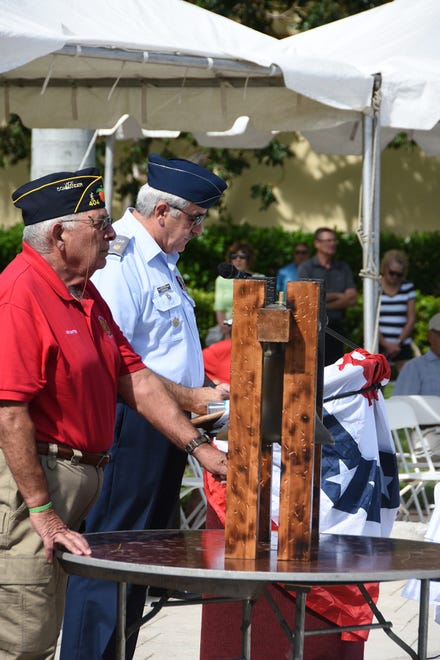 Bob Corriveau, right, and Joe Batte remember veterans who died in the past year.  Marco Island commemorated Veterans' Day on Monday, with a ceremony at 11 a.m. in Veterans' Community Park.