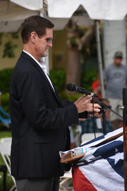 Marco Island City Manager Mike McNees adjusts the mic before speaking. Marco Island commemorated Veterans' Day on Monday, with a ceremony at 11 a.m. in Veterans' Community Park.