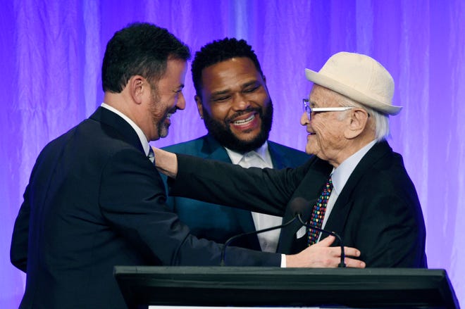 All-time producing great Norman Lear, right, embraces ABC late-night host Jimmy Kimmel, left, and 'Black-ish' star Anthony Anderson during a Paley Honors tribute to TV comedy legends.