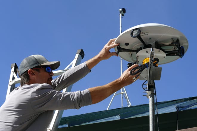 Alex Gonzalez from Thor Guard installs a lighting warning system at Caxambas Park and Boat Ramp in Marco Island on Feb. 4, 2020.