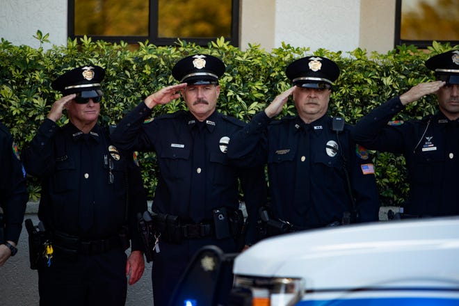 Members of the Marco Island Police Department salute as family members of Lt. Clayton Smith arrive during a memorial service, Monday, Feb. 10, 2020, at Marco Presbyterian Church.