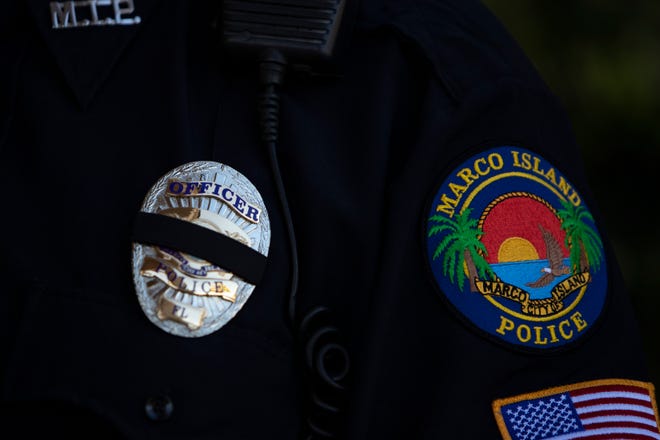 A black mourning band adorns the badge of a Marco Island police officers during a memorial service for their comrade Lt. Clayton Smith, Monday, Feb. 10, 2020, at Marco Presbyterian Church.