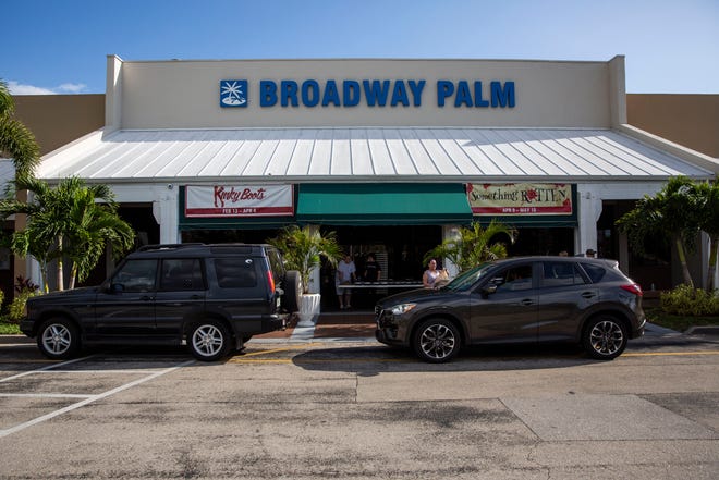 Volunteers hand out meals at Broadway Palm Dinner Theatre in Fort Myers on Saturday, March 21, 2020.
