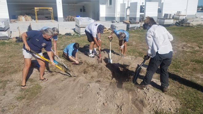 Staff and volunteers from Audubon Western Everglades dig in search of burrowing owl eggs or chicks following a the collapse of two owl burrows on 1631 Collingswood Court, Marco Island on May 8, 2020.