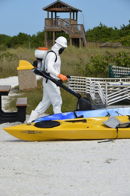 Technician Owen Maynard disinfects recreational equipment at Tigertail Beach. HydroClean Environmental Solutions is a startup dedicated to disinfecting local businesses to enhance customer safety.