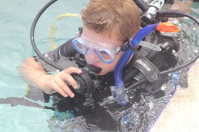 A young Scuba camper prepares to experience the magic of breathing underwater.