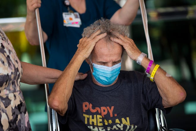 Richard Czekanski fixes his hair after being released from Physicians Regional Medical Center Pine Ridge in Naples on Thursday, June 11, 2020.
