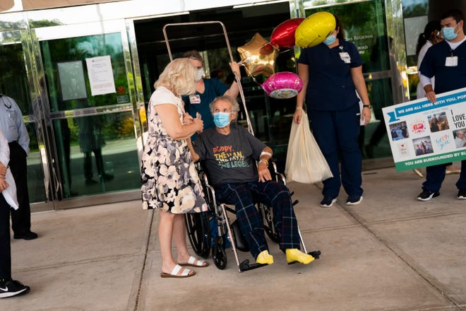 Gayle Czekanski holds hands with her husband, Richard Czekanski, after he was released from Physicians Regional Medical Center Pine Ridge in Naples on Thursday, June 11, 2020. Czekanski, 85, was released on his birthday after spending more than ten weeks at the hospital recovering from COVID-19.