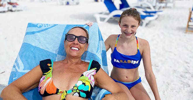 Sofia Wilson and her godmother, Fiddler's Creek resident Gail Warren, on the beach on Marco Island in May. Two young girls from 1,000 miles apart were connected when a message in bottle sent by one was found by the other, prompting communication and dreams.
