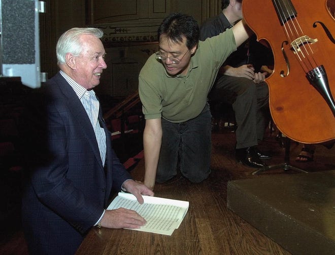 Hugh Downs, left, talks with cellist Yo-Yo Ma during the rehearsal of a composition written by Hugh Downs, titled "Windows," at Powell Symphony Hall in St. Louis on May 3, 2000.