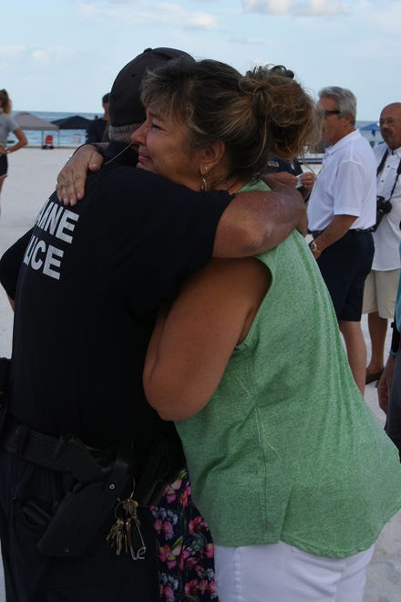 Lisa Smith gets a hug from a police officer. Dozens of police officers and supporters gathered at South Beach on Sunday morning to commemorate a memorial bench in honor of the late MIPD Lt. Clayton Smith.