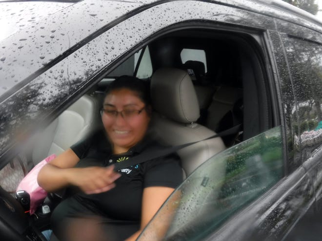 Petra Rosales said she has seen her hours cut at work. Our Daily Bread Food Pantry delivered much needed groceries to hungry recipients Friday afternoon at St. Mark's Episcopal Church from its moblie food pantry, despite a torrential downpour.