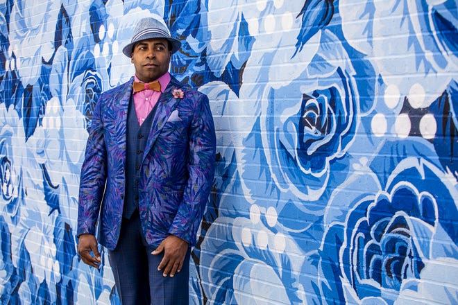 Derrick Clarkson models a cobalt and pastel floral Tallia sport coat, subtle navy plaid vest, raspberry shirt, hand-crafted harwood bow tie, lapel posey, pocket square and straw fedora during a Kentucky Derby fashion shoot with stylist Jo Ross at Churchill Downs. March 11, 2020